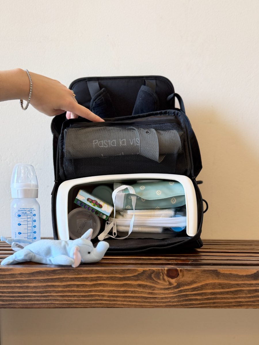 The Peekaseat packed with wipes, diapers, bottle and toys